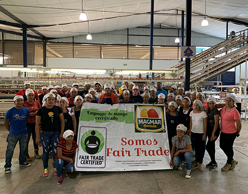 Image: workers gathering behind a sign for Somos Fair Trade banner